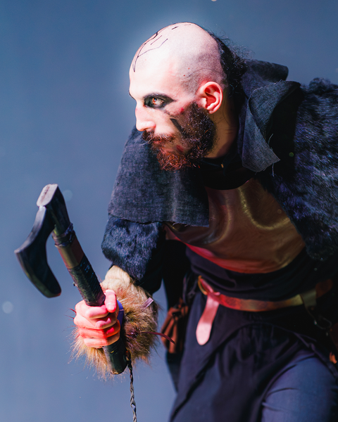 Cosplayer posing with a prop axe